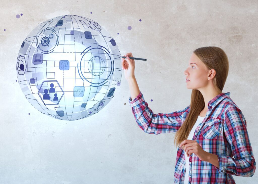 Woman in a plaid shirt holding a pen and drawing a floating, glowing orb in the air, meant to illustrate the extreme innovation that comes from Jacks-of-all-trades